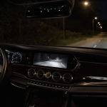 Luxury car interior with dashboard and night driving view using night vision technology
