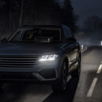 Automotive thermal night vision display highlighting a pedestrian on a dark road