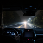 Car thermal night vision system displaying a pedestrian and vehicle on a dark road