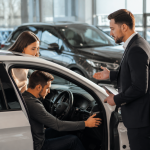 Buyer inspecting a used car to decide if it is worth buying