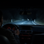 Vehicle thermal night vision display highlighting a pedestrian on a dark road